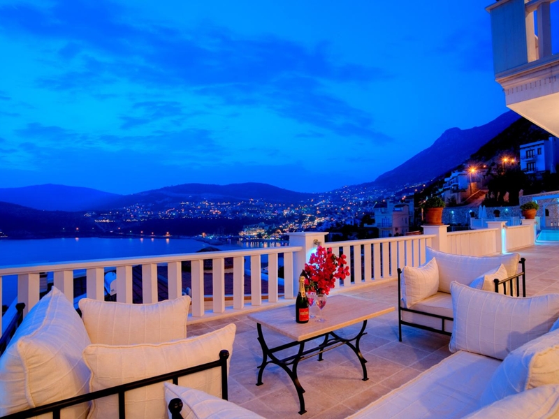 Watch the sun set behind the mountains with a glass of wine